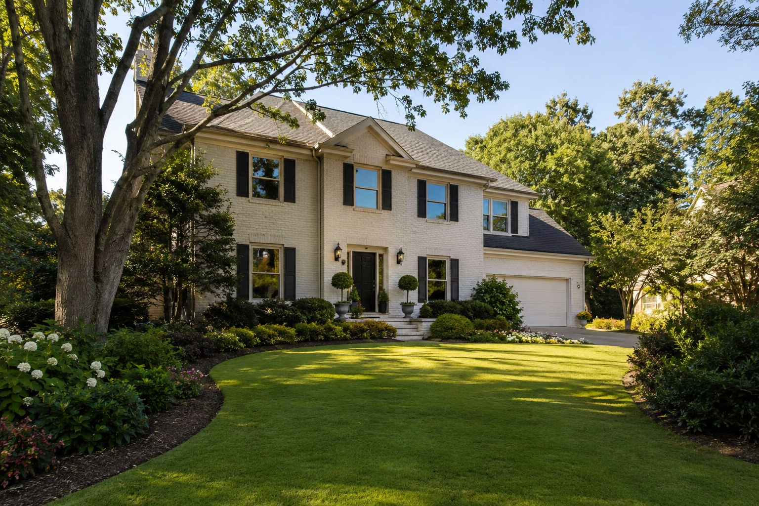 Two-story traditional home in Windward Alpharetta with mature landscaping